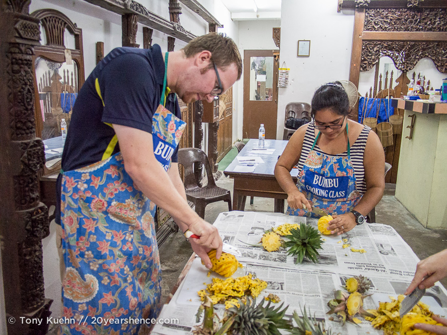 Steph and Tony carving pineapples at Bumbu Cooking Class