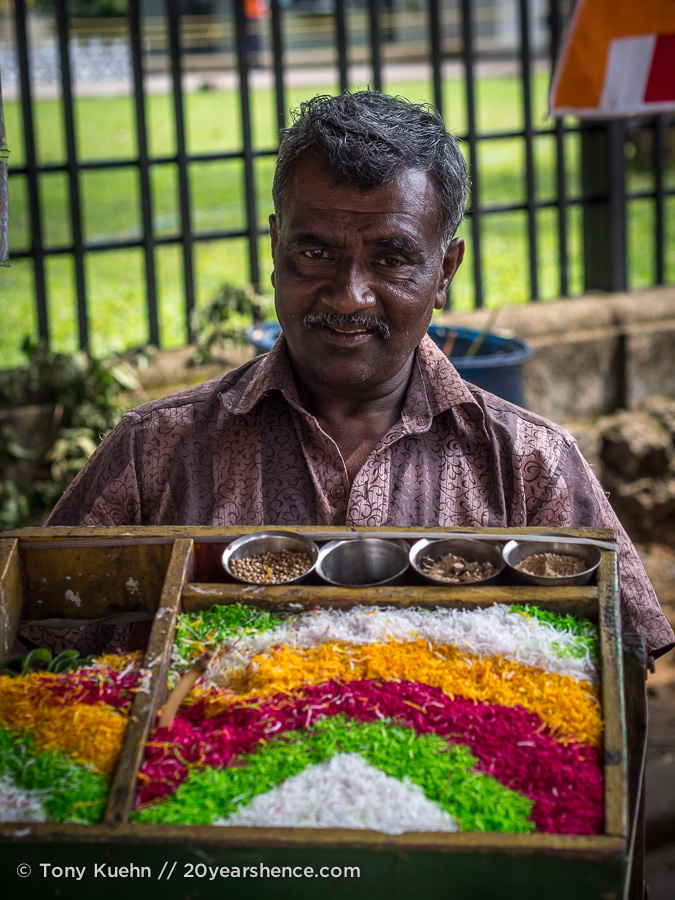 A flower market vendor outside the Temple of the Tooth, Kandy, Sri Lanka