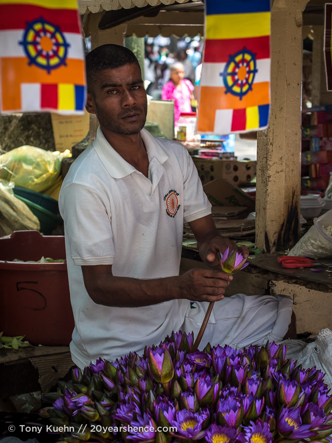 A flower market vendor outside the Temple of the Tooth, Kandy, Sri Lanka