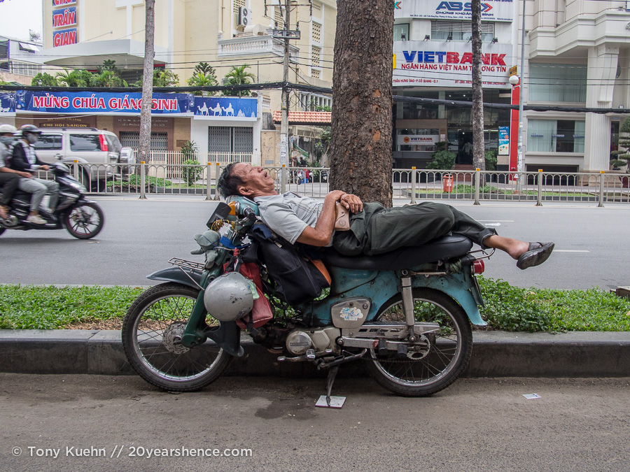Man sleeping on motorbike in Saigon